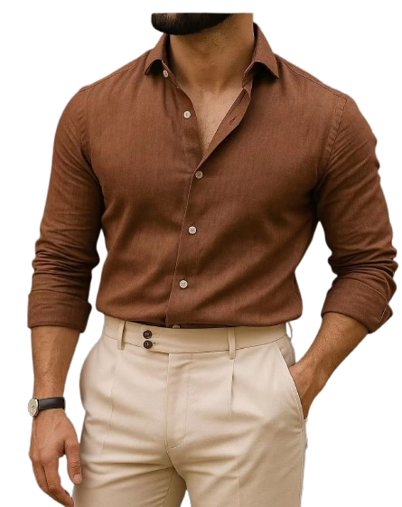 Person wearing cream-colored shirt and pleated trousers with hands in pockets.